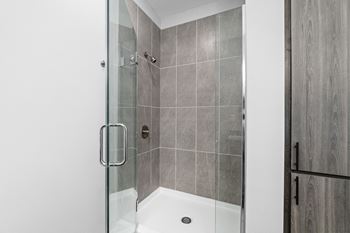 Walk-in tile shower w/ glass enclosure